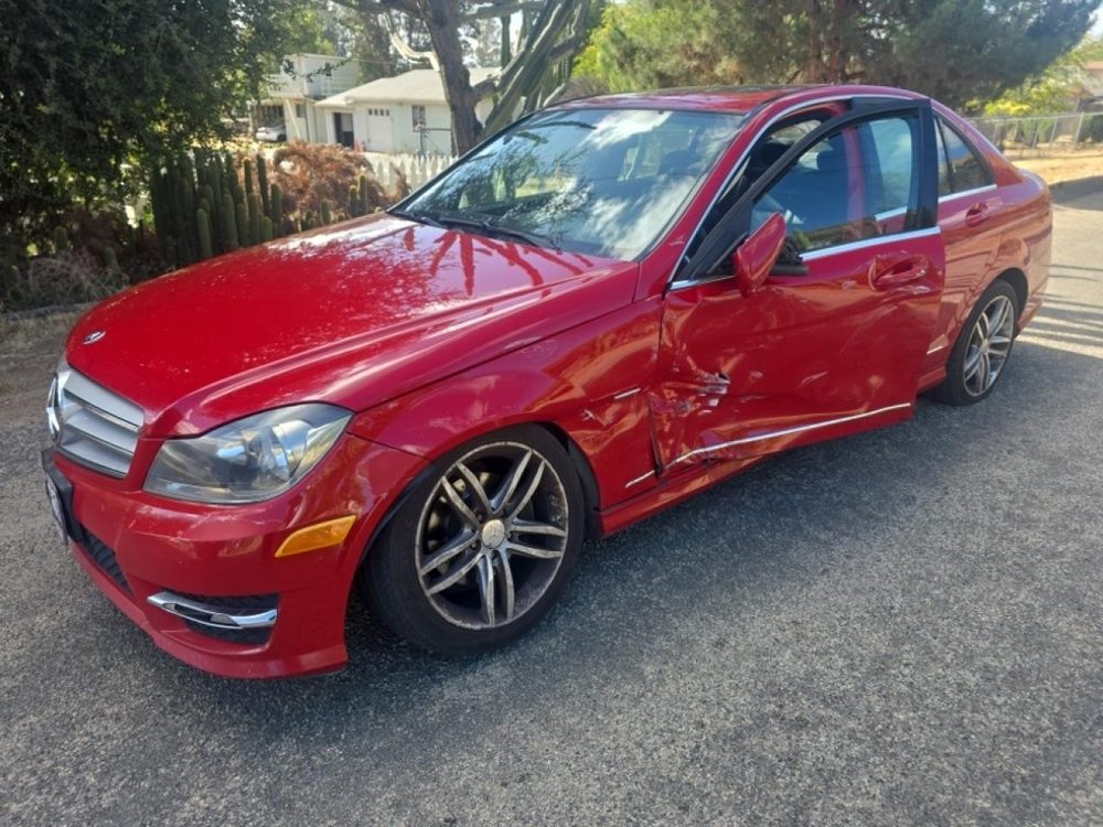 Red Mercedes-Benz C-Class with driver side collision damage, purchased by California Wrecked Cars